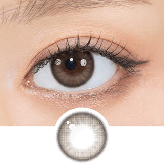 Close-up shot of model's eye adorned with Gemhour Theia Glow Brown daily color contact lenses with prescription, complemented by clean eye makeup, showing the brightening and enlarging effect of the circle contact lens on dark brown eyes, above a cutout of the contact lens pattern with limbal ring on a white background.