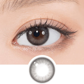Close-up shot of model's eye adorned with Gemhour Theia Glow Black daily color contact lenses with prescription, complemented by clean eye makeup, showing the brightening and enlarging effect of the circle contact lens on dark brown eyes, above a cutout of the contact lens pattern with limbal ring on a white background.