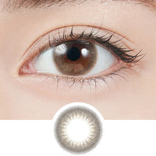 Close-up shot of model's eye adorned with Topards 1-Day Opal (10pk) daily color contact lenses with prescription, paired with clean-girl eye makeup, showing the brightening and enlarging effect of the circle contact lens on dark brown eyes, above a cutout of the contact lens with limbal ring on a white background.