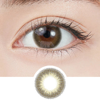 Close-up shot of model's eye adorned with Topards 1-Day Twin Topaz (10pk) daily color contact lenses with prescription, paired with clean-girl eye makeup, showing the brightening and enlarging effect of the circle contact lens on dark brown eyes, above a cutout of the contact lens with limbal ring on a white background.