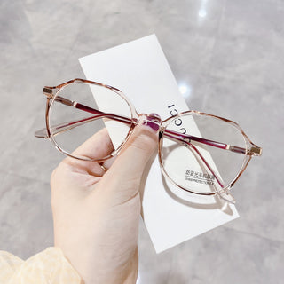 Elegant Pink glasses on a white surface, representing EyeCandys Vera Round vintage frames with Blue Light Blocking, Transitions and polarized options