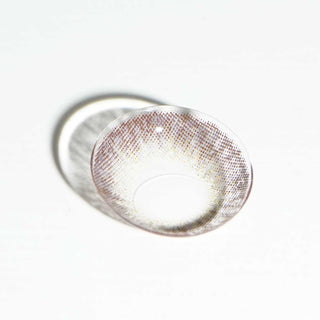 Macro shot of EyeCandys Pink Label Vintage Grey prescription contact lenses, showcasing a soft, natural grey hue with intricate design details. The lens offers a subtle, brightening effect that enhances the eye's natural color, perfect for a captivating, refined look. These lenses provide comfort for daily wear and are available in various prescriptions