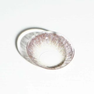 Macro shot of EyeCandys Pink Label Vintage Grey prescription contact lenses, showcasing a soft, natural grey hue with intricate design details. The lens offers a subtle, brightening effect that enhances the eye's natural color, perfect for a captivating, refined look. These lenses provide comfort for daily wear and are available in various prescriptions