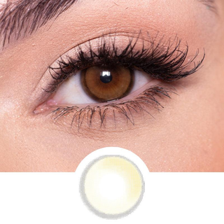 A brown contact lens on top of a brown eye with blue artistic eye makeup and long eyelashes, above the design of the contact lens itself.
