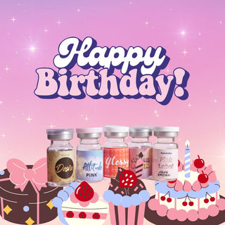 Five small decorative bottles are lined up in front of illustrated cakes and cupcakes. Above them, bold text reads "Happy Birthday!" on a pink and purple gradient background with sparkles.