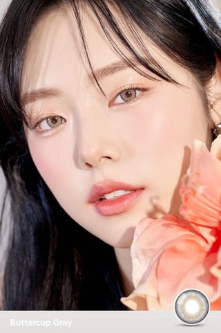 A close-up of a model demonstrating a natural makeup look with Ann365 Buttercup Grey circle colour contacts, highlighting how well the contact lenses blend with her dark eyes.