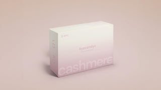 A white and light pink box labeled "eyecandys" and "cashmere" sits on a beige surface. The packaging suggests it contains contact lenses. The design is minimal with soft gradients and subtle text.