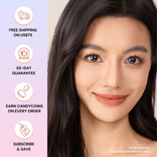 Model with natural makeup wearing EyeCandys Amelie Earl Grey prescription colored contact lens, enhancing eyes with soft grey tones.