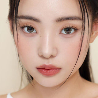 Asian model demonstrating a K-idol-inspired look with Olive Green daily coloured contact lenses, highlighting the instant brightening and enlarging effect of the circle contact lenses over dark irises.