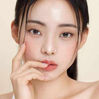 Asian model demonstrating a K-idol-inspired look with Olive Green daily coloured contact lenses, highlighting the instant brightening and enlarging effect of the circle contact lenses over dark irises.