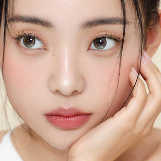 Asian model demonstrating a K-idol-inspired look with Olive Green daily coloured contact lenses, highlighting the instant brightening and enlarging effect of the circle contact lenses over dark irises.