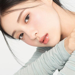 Asian model demonstrating a K-idol-inspired look with 1-Day Pebble Grey coloured contact lenses, highlighting the instant brightening and enlarging effect of the circle contact lenses over dark irises.