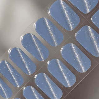 EyeCandys Denim Sugar Gel nail sticker featuring a rich denim blue shade with subtle silver glitter. This semi-cured gel design offers a sparkly, textured look that’s perfect for edgy, cool-toned manicures with salon-quality shine and effortless application.