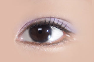 Close-up of a naturally dark brown eye with long natural eyelashes