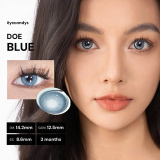 Model with long lashes wearing EyeCandys Doe Blue prescription colored contact lens, close-up showing eye color enhancement.