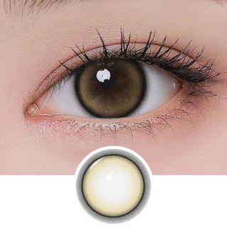Close-up of eye with long lashes wearing EyeCandys I-Girl One Pick Natural Beige contact lens, showing detailed lens design below