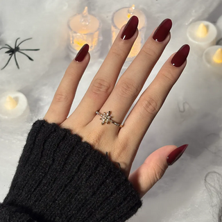 Hand with EyeCandys Wine Not Gel Nail Stickers in deep burgundy red — salon-quality, long-lasting, non-toxic manicure for elegant everyday glam.