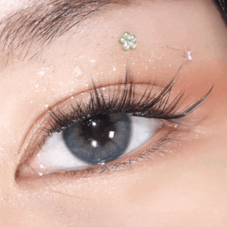 Close-up video of blinking eye with long lashes wearing EyeCandys Pink Label Mallorca Blue – vivid blue prescription colored contact lenses. Comfortable color contact lenses for a bold, natural look.