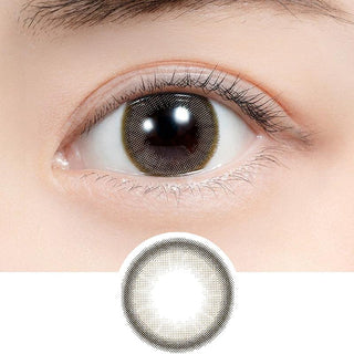 Close-up shot of model's eye adorned with Feliamo 1-Day Airy Beige (10pk) daily color contact lenses with prescription, paired with clean-girl eye makeup, showing the brightening and enlarging effect of the circle contact lens on dark brown eyes, above a cutout of the contact lens with limbal ring on a white background.