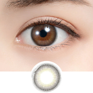 Close-up shot of model's eye adorned with Feliamo 1-Day Coffee Jelly (10pk) daily color contact lenses with prescription, paired with clean-girl eye makeup, showing the brightening and enlarging effect of the circle contact lens on dark brown eyes, above a cutout of the contact lens with limbal ring on a white background.