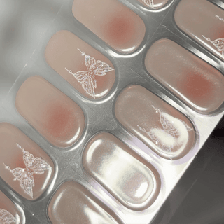 EyeCandys Flutter Gel nail sticker featuring a translucent pink base with delicate white butterfly accents. This semi-cured gel set offers a dreamy, feminine aesthetic with a glossy finish—perfect for soft glam or romantic manicures.