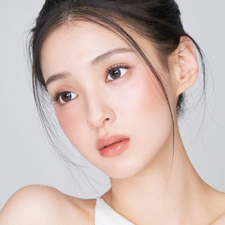 Asian model demonstrating a K-idol-inspired look with 1-Day Grey coloured contact lenses, highlighting the instant brightening and enlarging effect of the circle contact lenses over dark irises.
