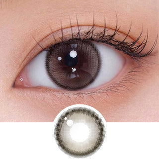 Close-up shot of model's eye adorned with Gemhour Demeter 1-Day Ash Choco (10pk) daily color contact lenses with prescription, complemented by clean eye makeup, showing the brightening and enlarging effect of the circle contact lens on dark brown eyes, above a cutout of the contact lens pattern with limbal ring on a white background.