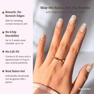 Hand displaying EyeCandys Gilt Lines press on nails with creamy white base, bold 3D gel details, and gold architectural linework nail design.