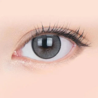 Macro shot of an eye wearing the i-Sha Jadey Mono Grey prescription colour contact lens, showing the multi-colored detail and natural effect on dark brown eyes.