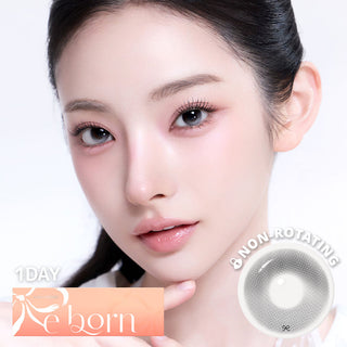 Beauty portrait of a woman wearing gray contact lenses, with a clean makeup, and a non-rotating lens design overly with 1-day Reborn branding.
