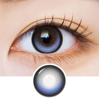 Close-up of an eye with long lashes wearing EyeCandys i-Sha Dekame Kiss Me 1-Day Blue Pop colored contact lenses, showing the lens design pattern