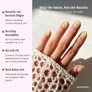 Close up hand showcasing EyeCandys Lemon Drops press on nails with glossy yellow cat-eye nails and glass-like shimmer finish.