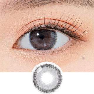 Close-up shot of a model's eye wearing Lensrang Comely Grey color contacts with prescription, paired with K-beauty-inspired eye makeup, showing the brightening and enlarging effect of the circle contact lens on dark brown eyes, above a cutout of the contact lens pattern with limbal ring on a white background.