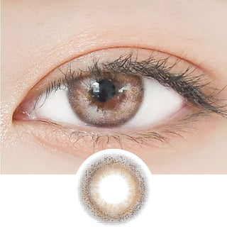 Close-up shot of a model's eye wearing Lensrang Credit Brown color contacts with prescription, paired with K-beauty-inspired eye makeup, showing the brightening and enlarging effect of the circle contact lens on dark brown eyes, above a cutout of the contact lens pattern with limbal ring on a white background.