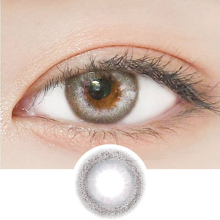 Close-up shot of a model's eye wearing Lensrang Credit Grey color contacts with prescription, paired with K-beauty-inspired eye makeup, showing the brightening and enlarging effect of the circle contact lens on dark brown eyes, above a cutout of the contact lens pattern with limbal ring on a white background.