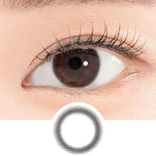 Close-up shot of a model's eye wearing Lensrang Iwwing Black color contacts with prescription, paired with K-beauty-inspired eye makeup, showing the brightening and enlarging effect of the circle contact lens on dark brown eyes, above a cutout of the contact lens pattern with limbal ring on a white background.