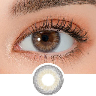 Close-up shot of a model's eye wearing Lensrang Iwwinka Grey color contacts with prescription, paired with K-beauty-inspired eye makeup, showing the brightening and enlarging effect of the circle contact lens on dark brown eyes, above a cutout of the contact lens pattern with limbal ring on a white background.