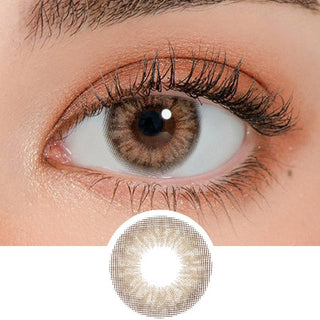 Close-up shot of a model's eye wearing Lensrang Iwwinka Hazel color contacts with prescription, paired with K-beauty-inspired eye makeup, showing the brightening and enlarging effect of the circle contact lens on dark brown eyes, above a cutout of the contact lens pattern with limbal ring on a white background.