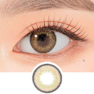 Close-up shot of a model's eye wearing Lensrang Iwwitch Brown color contacts with prescription, paired with K-beauty-inspired eye makeup, showing the brightening and enlarging effect of the circle contact lens on dark brown eyes, above a cutout of the contact lens pattern with limbal ring on a white background.