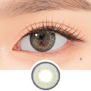 Close-up shot of a model's eye wearing Lensrang Iwwitch Grey color contacts with prescription, paired with K-beauty-inspired eye makeup, showing the brightening and enlarging effect of the circle contact lens on dark brown eyes, above a cutout of the contact lens pattern with limbal ring on a white background.