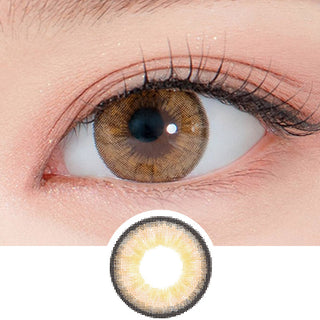 Close-up shot of a model's eye wearing Lensrang Iwwitch Up Brown color contacts with prescription, paired with K-beauty-inspired eye makeup, showing the brightening and enlarging effect of the circle contact lens on dark brown eyes, above a cutout of the contact lens pattern with limbal ring on a white background.