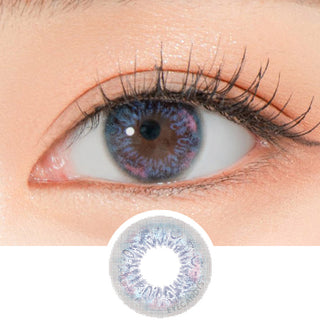 Close-up shot of a model's eye wearing Lensrang Narcissus Blue Grey color contacts with prescription, paired with K-beauty-inspired eye makeup, showing the brightening and enlarging effect of the circle contact lens on dark brown eyes, above a cutout of the contact lens pattern with limbal ring on a white background.