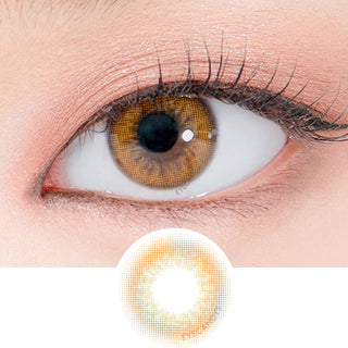 Close-up shot of a model's eye wearing Lensrang Real Brown color contacts with prescription, paired with K-beauty-inspired eye makeup, showing the brightening and enlarging effect of the circle contact lens on dark brown eyes, above a cutout of the contact lens pattern with limbal ring on a white background.