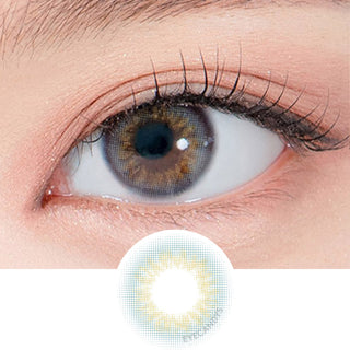 Close-up shot of a model's eye wearing Lensrang Real Ocean Grey color contacts with prescription, paired with K-beauty-inspired eye makeup, showing the brightening and enlarging effect of the circle contact lens on dark brown eyes, above a cutout of the contact lens pattern with limbal ring on a white background.