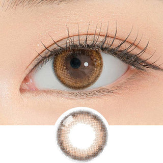 Close-up shot of a model's eye wearing Lensrang School Ring Brown color contacts with prescription, paired with K-beauty-inspired eye makeup, showing the brightening and enlarging effect of the circle contact lens on dark brown eyes, above a cutout of the contact lens pattern with limbal ring on a white background.