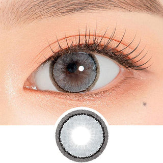 Close-up shot of a model's eye wearing Lensrang Sharing Grey color contacts with prescription, paired with K-beauty-inspired eye makeup, showing the brightening and enlarging effect of the circle contact lens on dark brown eyes, above a cutout of the contact lens pattern with limbal ring on a white background.