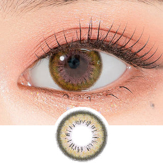 Close-up shot of a model's eye wearing Lensrang Spell Green color contacts with prescription, paired with K-beauty-inspired eye makeup, showing the brightening and enlarging effect of the circle contact lens on dark brown eyes, above a cutout of the contact lens pattern with limbal ring on a white background.