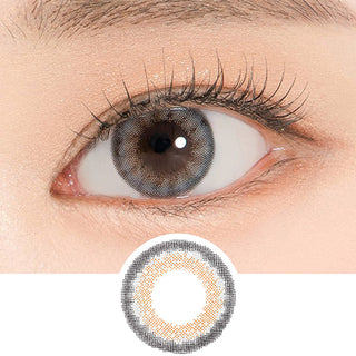 Close-up shot of a model's eye wearing Lensrang Stunning Grey color contacts with prescription, paired with K-beauty-inspired eye makeup, showing the brightening and enlarging effect of the circle contact lens on dark brown eyes, above a cutout of the contact lens pattern with limbal ring on a white background.