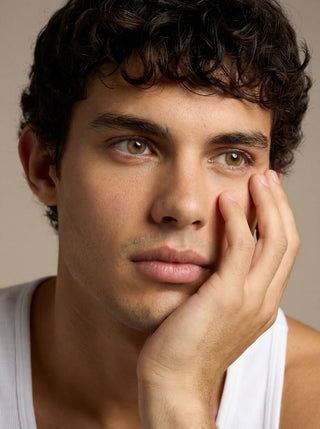 Portrait of male model wearing EyeCandys Cashmere Satin Olive colored contact lenses, subtle and realistic eye enhancement