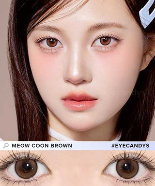 A female model with natural dark eyes wearing Olala Meow Coon Brown contact lenses, complemented by subtle eyeshadow and peach lip gloss and Close-up image showcases the model's eyes adorned with the same brown contact lenses